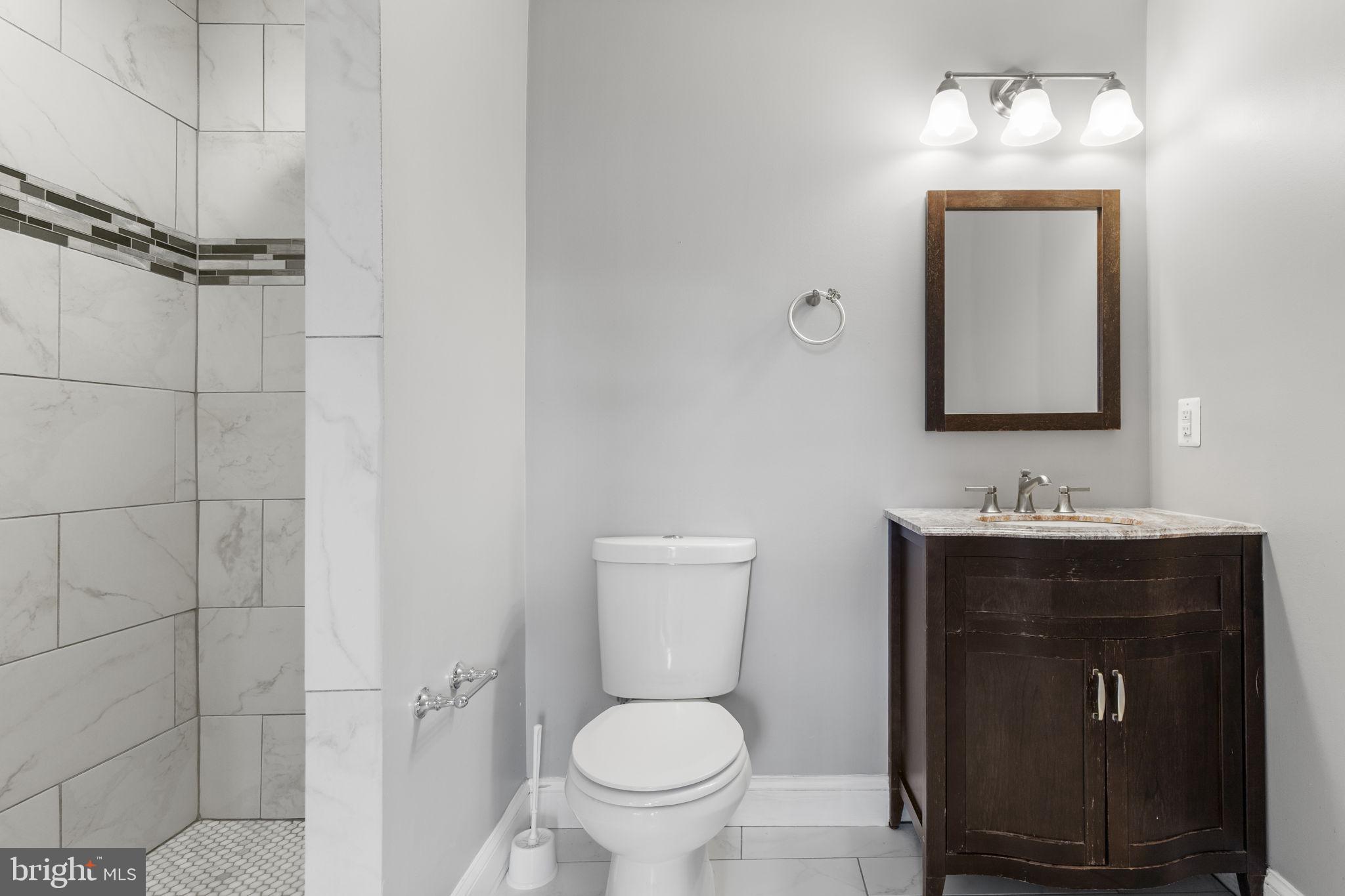 625 Savage Street Baltimore, MD 21224 - Photo 16 of 26 a bathroom with a toilet sink and mirror