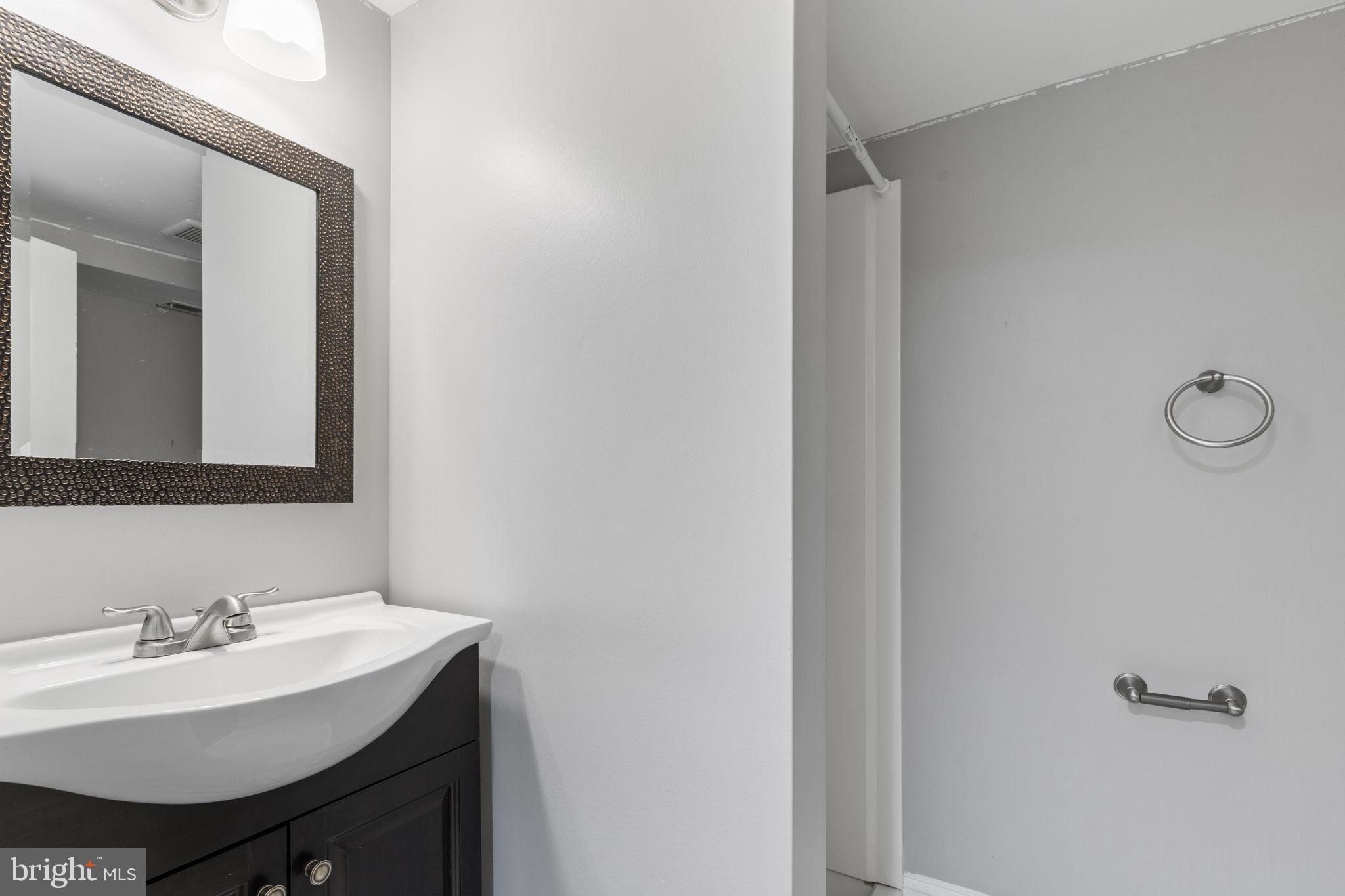 625 Savage Street Baltimore, MD 21224 - Photo 20 of 26 a bathroom with a sink and a mirror