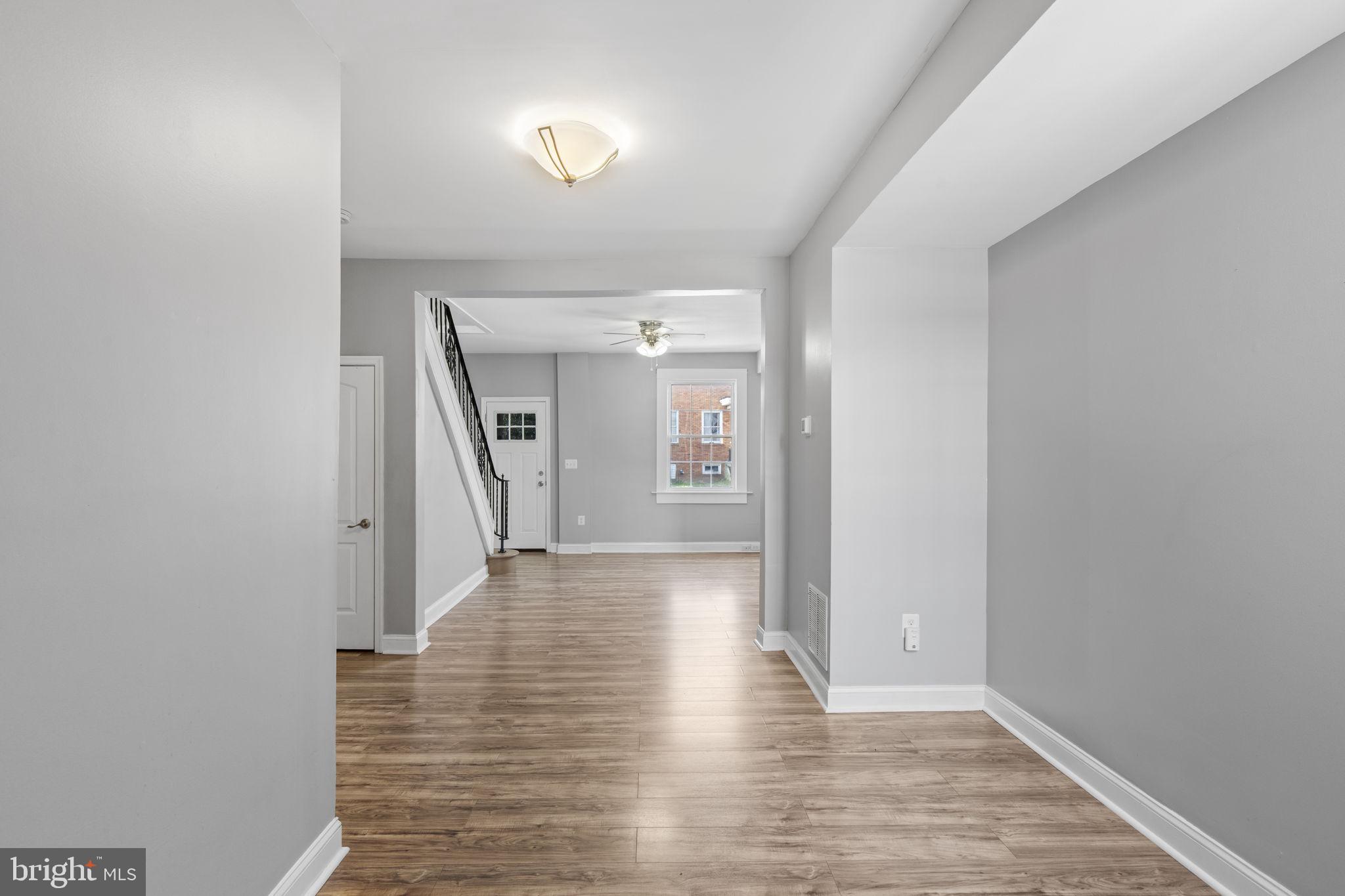 625 Savage Street Baltimore, MD 21224 - Photo 3 of 26 a view of a hallway view with wooden floor and staircase