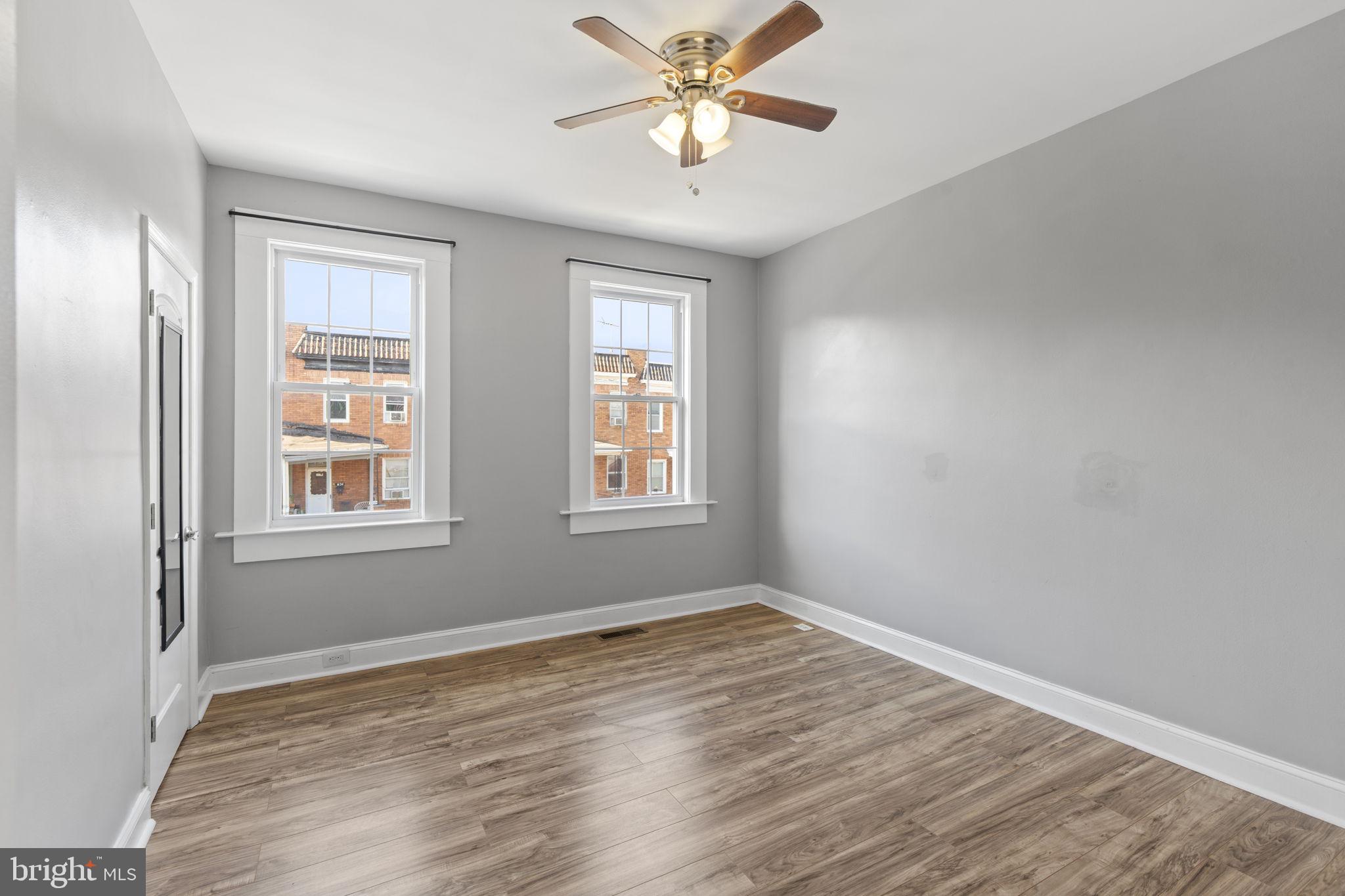 625 Savage Street Baltimore, MD 21224 - Photo 10 of 26 a view of an empty room with window and wooden floor