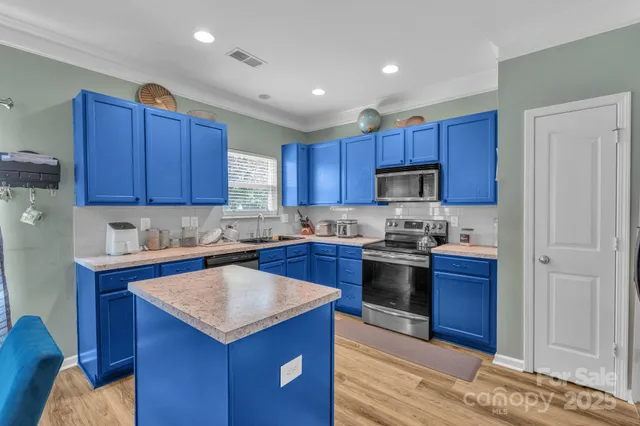 a kitchen with a stove sink and cabinets