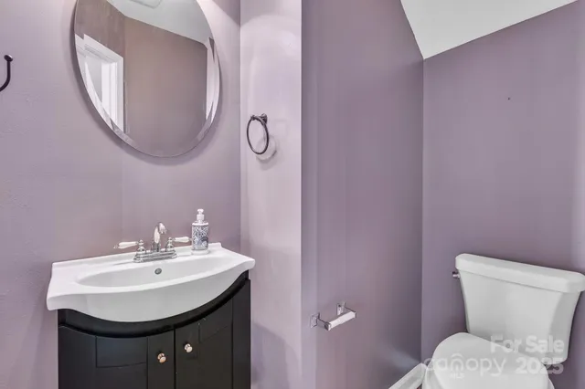 a bathroom with a sink a mirror and a toilet