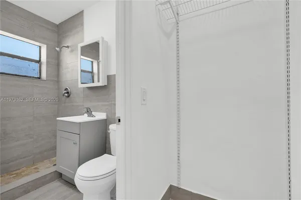 a white toilet sitting next to a bathroom sink