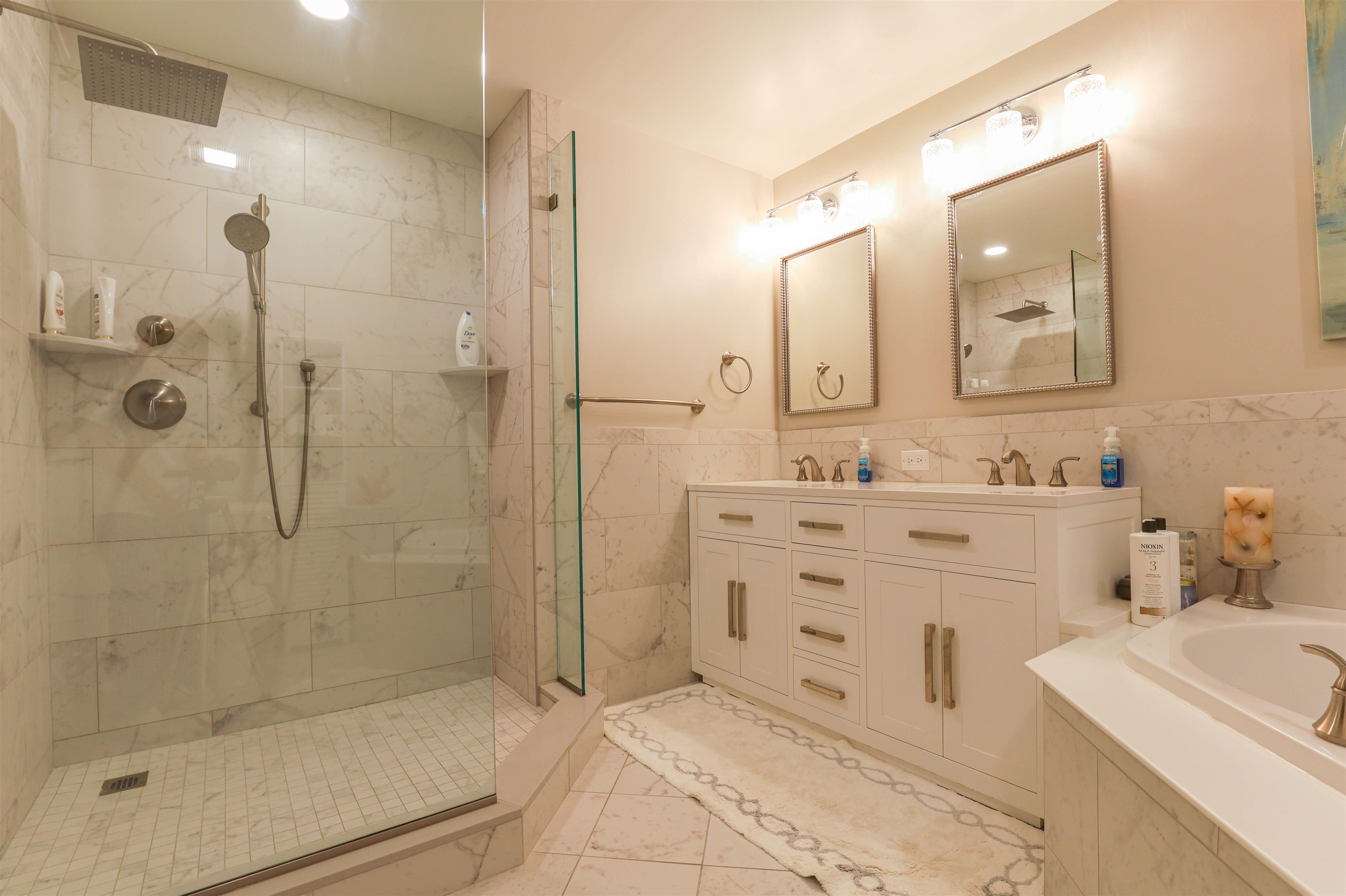 7701 Atlantic Avenue, Unit 102 Wildwood Crest, NJ 08260 - Photo 13 of 25 a bathroom with a sink mirror and a shower