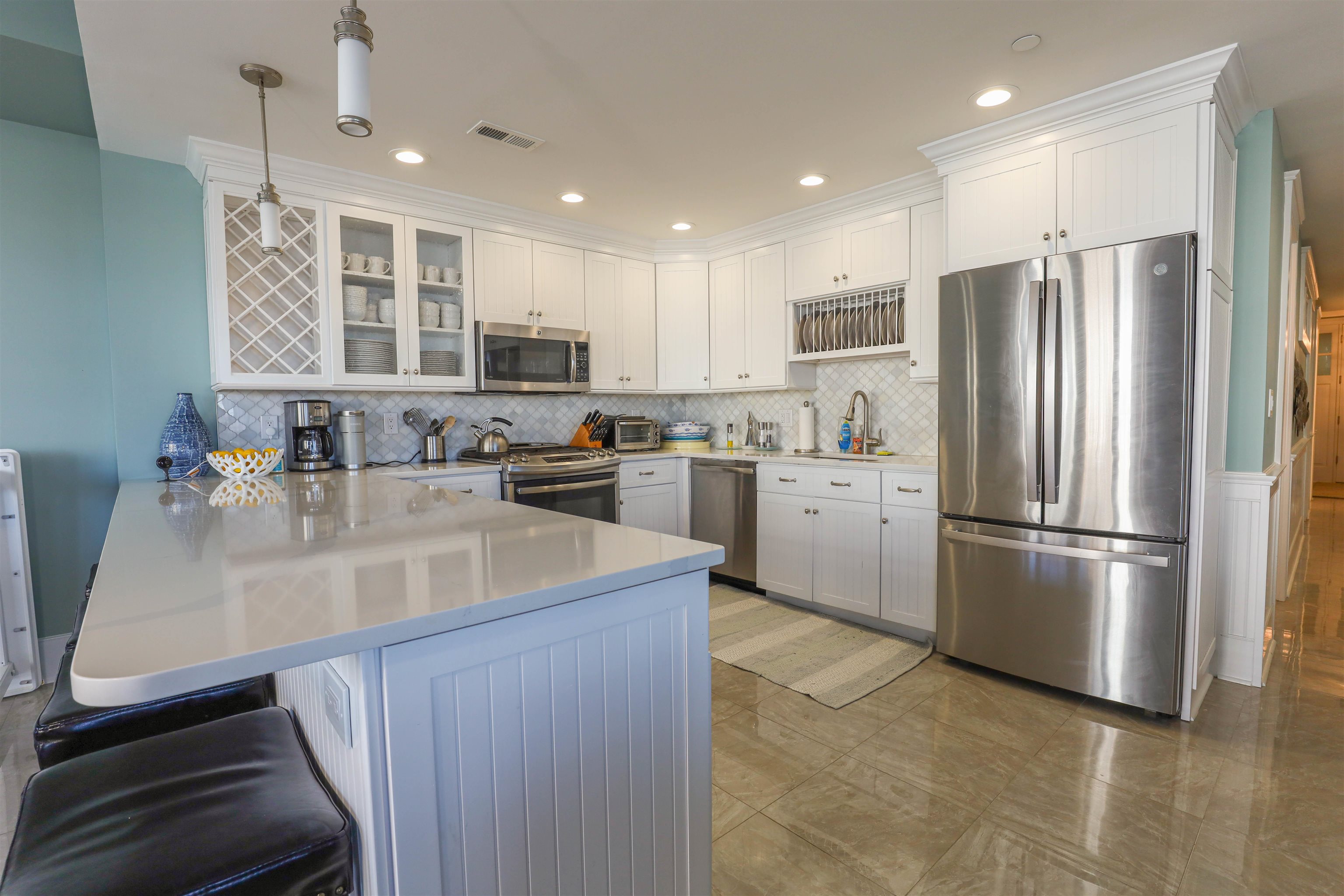 7701 Atlantic Avenue, Unit 102 Wildwood Crest, NJ 08260 - Photo 5 of 25 a kitchen with stainless steel appliances granite countertop a sink stove and refrigerator