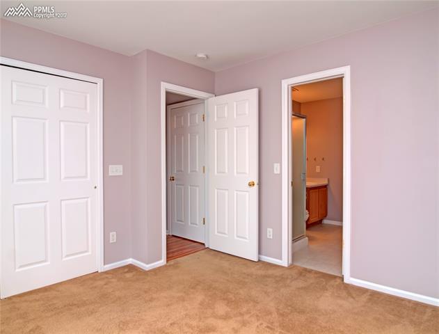 7680 Tompkins Road Peyton, CO 80831 - Photo 19 of 30 Main-level bedroom with attached 3/4 bath