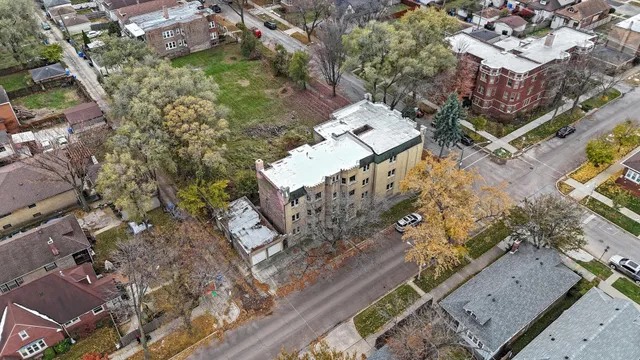 an aerial view of a house with a yard