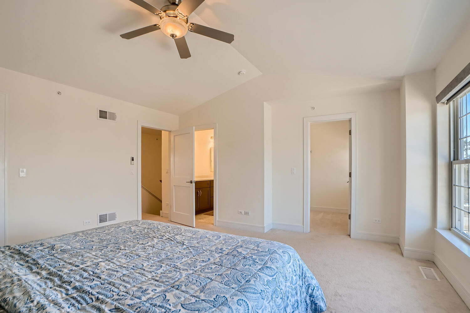 2603 Chelsey Street Buffalo Grove, IL 60089 - Photo 14 of 28 a view of a bedroom with a bed and a chandelier fan