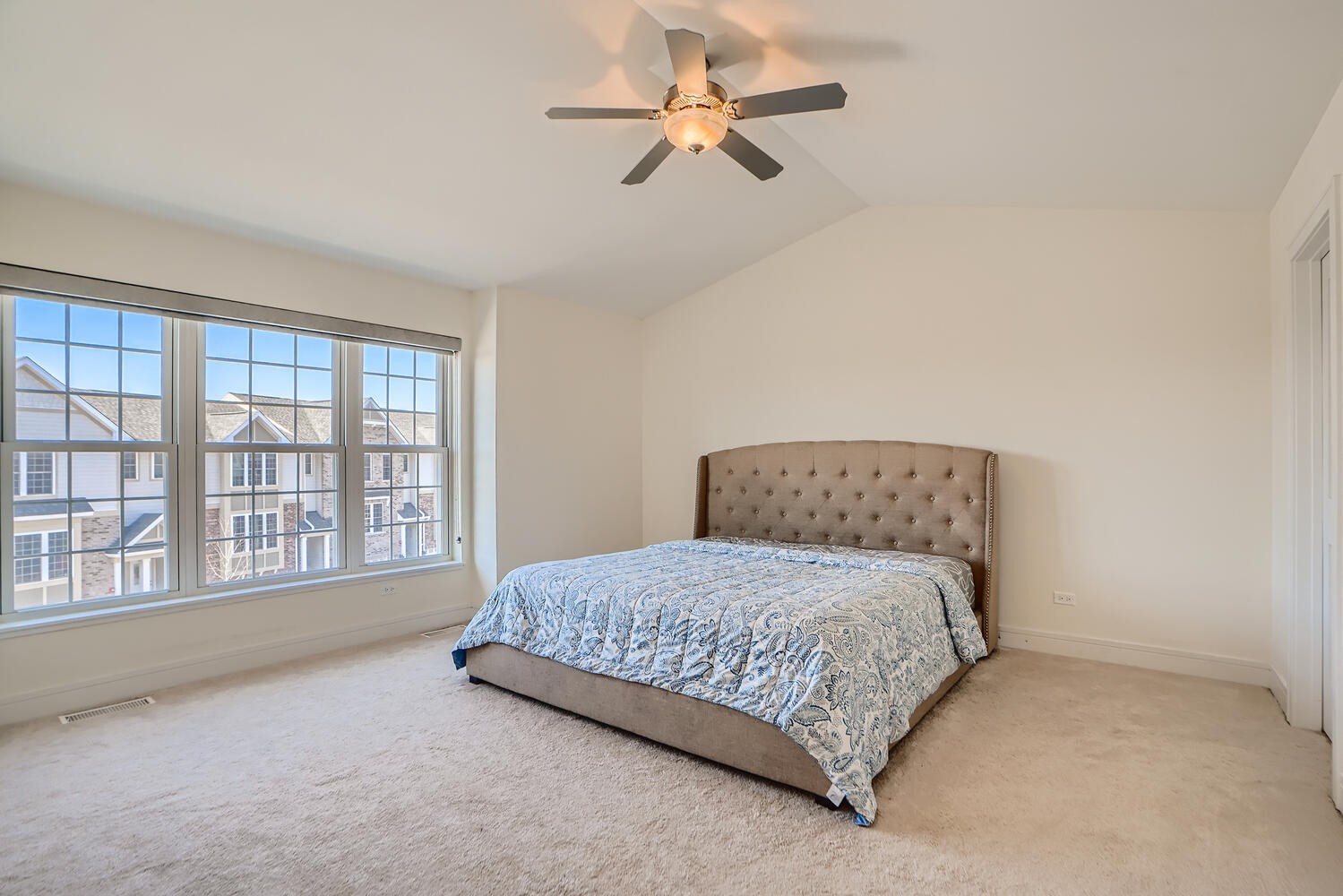2603 Chelsey Street Buffalo Grove, IL 60089 - Photo 15 of 28 a bedroom with a large bed and a chandelier fan