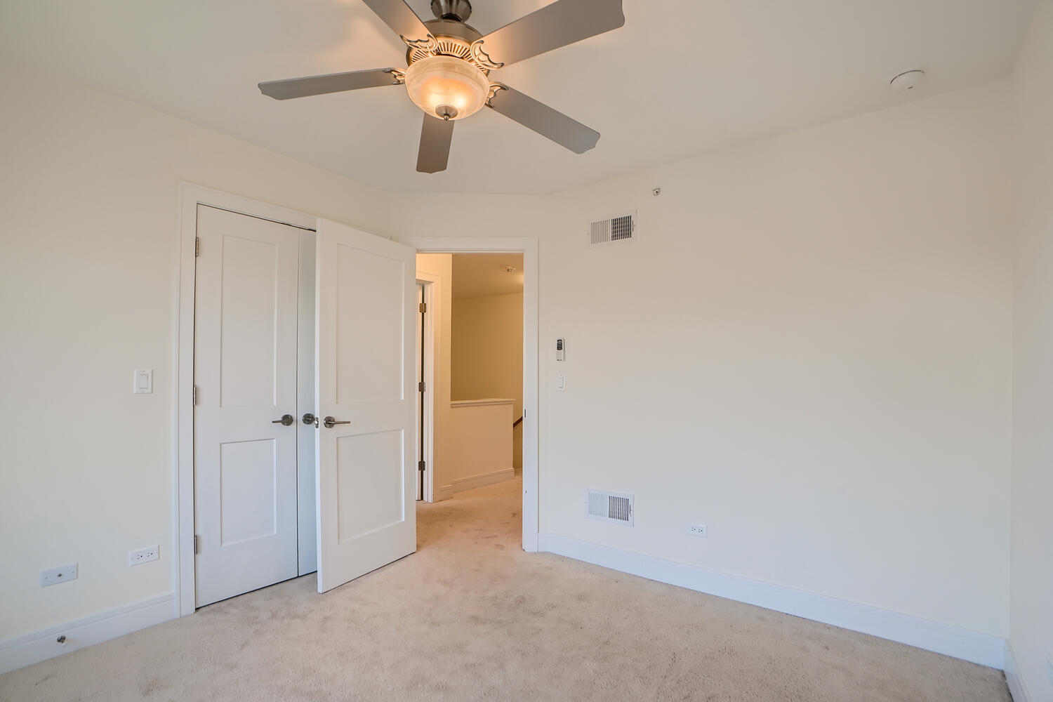2603 Chelsey Street Buffalo Grove, IL 60089 - Photo 19 of 28 an empty room with a ceiling fan and a fan