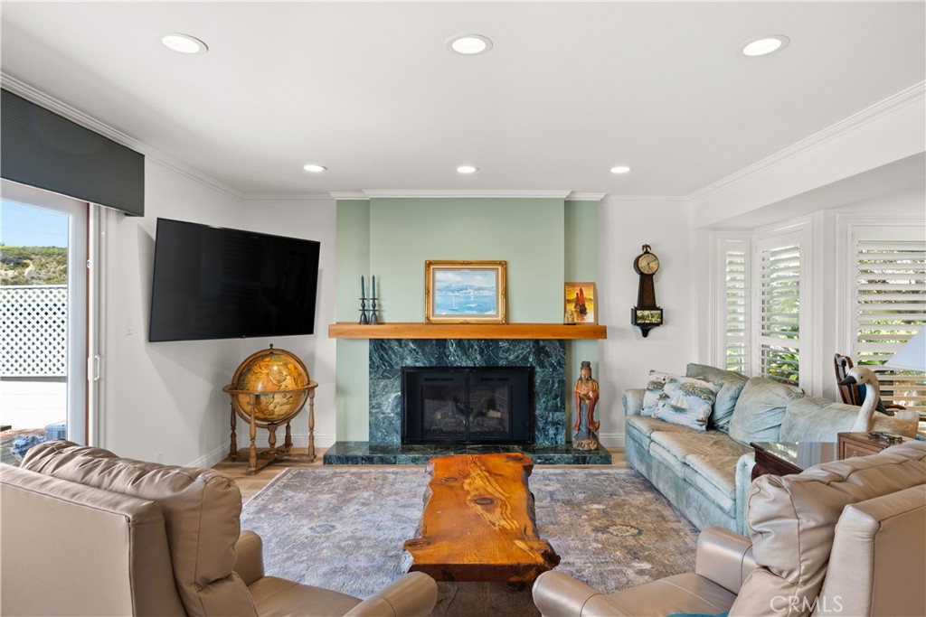5 Canal Circle Newport Beach, CA 92663 - Photo 11 of 30 a living room with furniture a flat screen tv and a fireplace