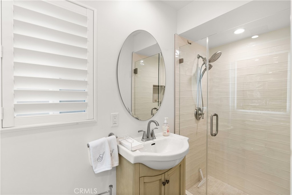5 Canal Circle Newport Beach, CA 92663 - Photo 13 of 30 a bathroom with a sink a mirror and a shower
