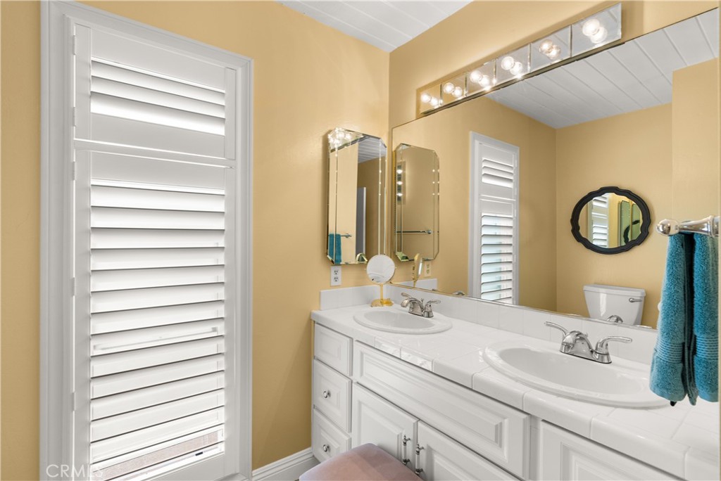 5 Canal Circle Newport Beach, CA 92663 - Photo 15 of 30 a bathroom with a sink and a mirror