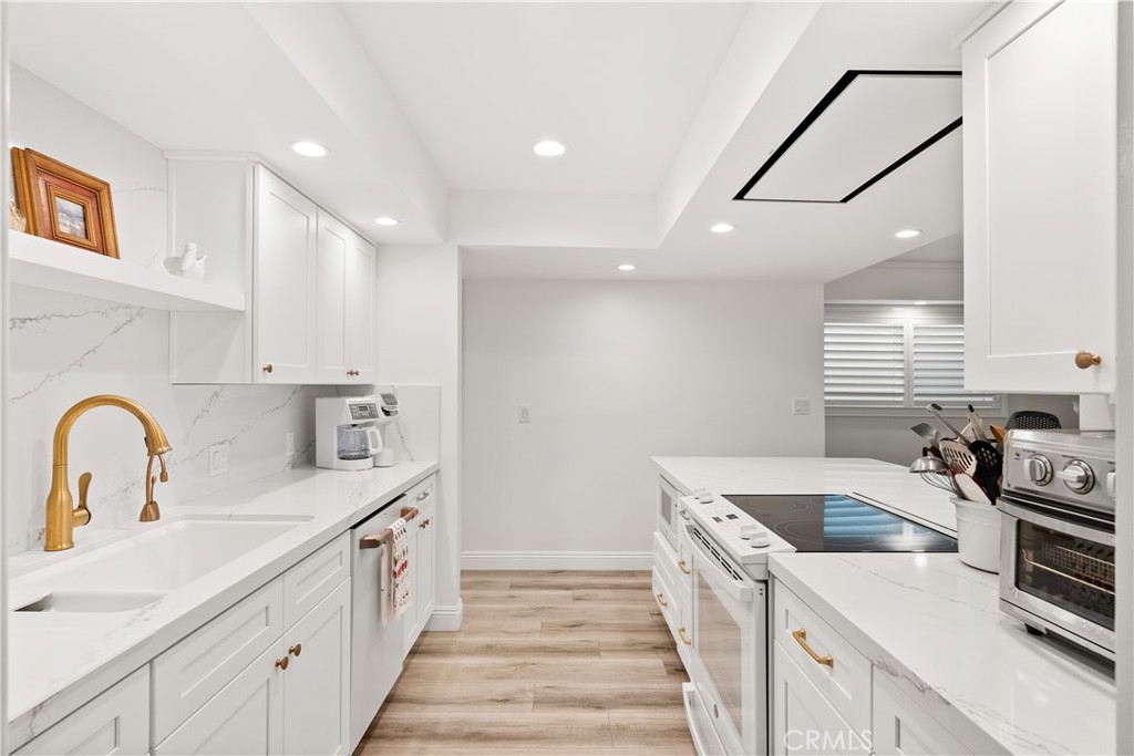 5 Canal Circle Newport Beach, CA 92663 - Photo 5 of 30 a kitchen with a sink and a stove top oven