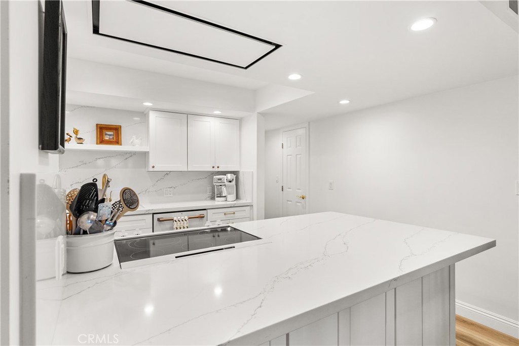 5 Canal Circle Newport Beach, CA 92663 - Photo 7 of 30 a kitchen with a sink stove and cabinets