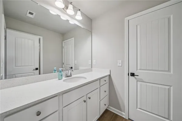 a bathroom with a sink a vanity and a mirror