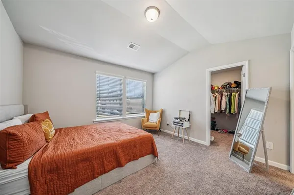 a bedroom with furniture and a window