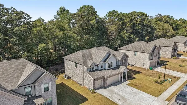 aerial view of a house with yard and furniture