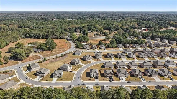 an aerial view of a house with a yard
