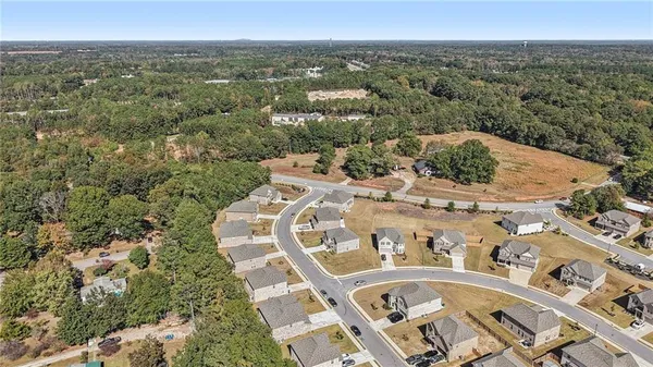an aerial view of a house with a yard