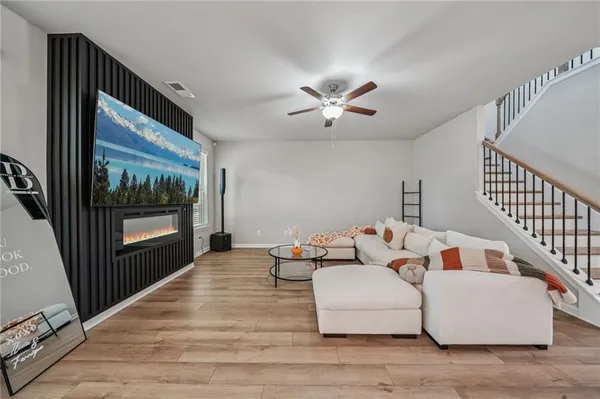 a living room with furniture and a floor to ceiling window