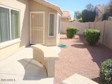 a living room with a couch and a potted plant