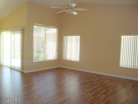 14845 West Merrell Street Goodyear, AZ 85395 - Photo 4 of 14 a view of an empty room with wooden floor and a window
