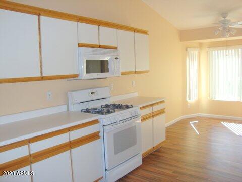14845 West Merrell Street Goodyear, AZ 85395 - Photo 7 of 14 a kitchen with a stove a sink and a microwave