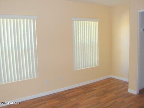 14845 West Merrell Street Goodyear, AZ 85395 - Photo 8 of 14 an empty room with wooden floor and windows