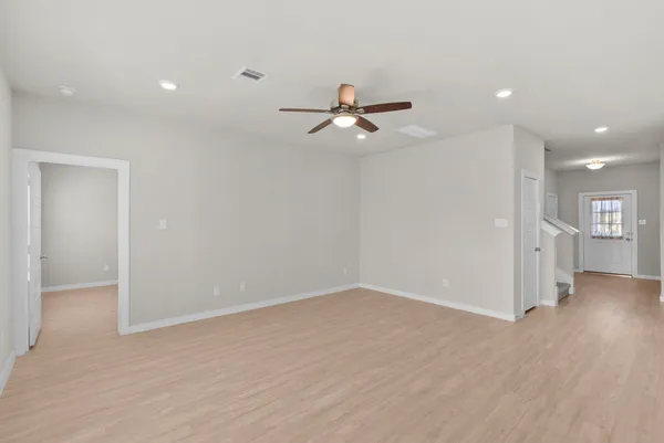 a kitchen with stainless steel appliances granite countertop a sink a stove a refrigerator a microwave and white cabinets