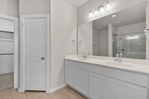 a bathroom that has a glass shower door