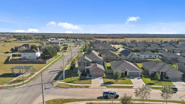 an aerial view of residential houses with outdoor space