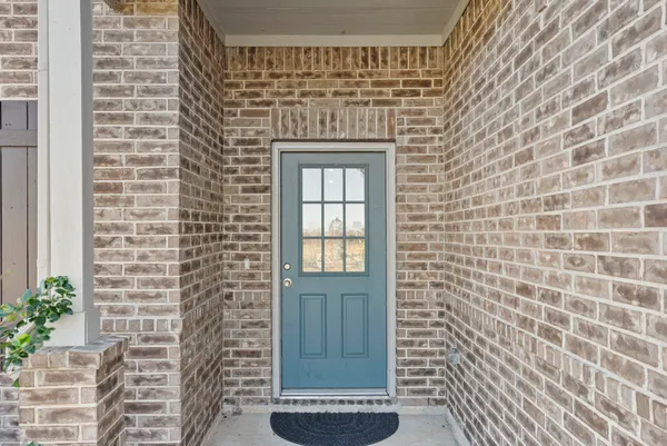 a view of a hallway with wooden floor and entryway