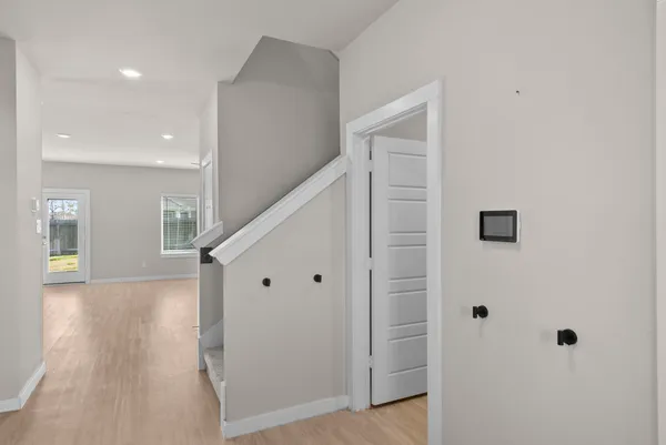 a view of an empty room with closet and a window