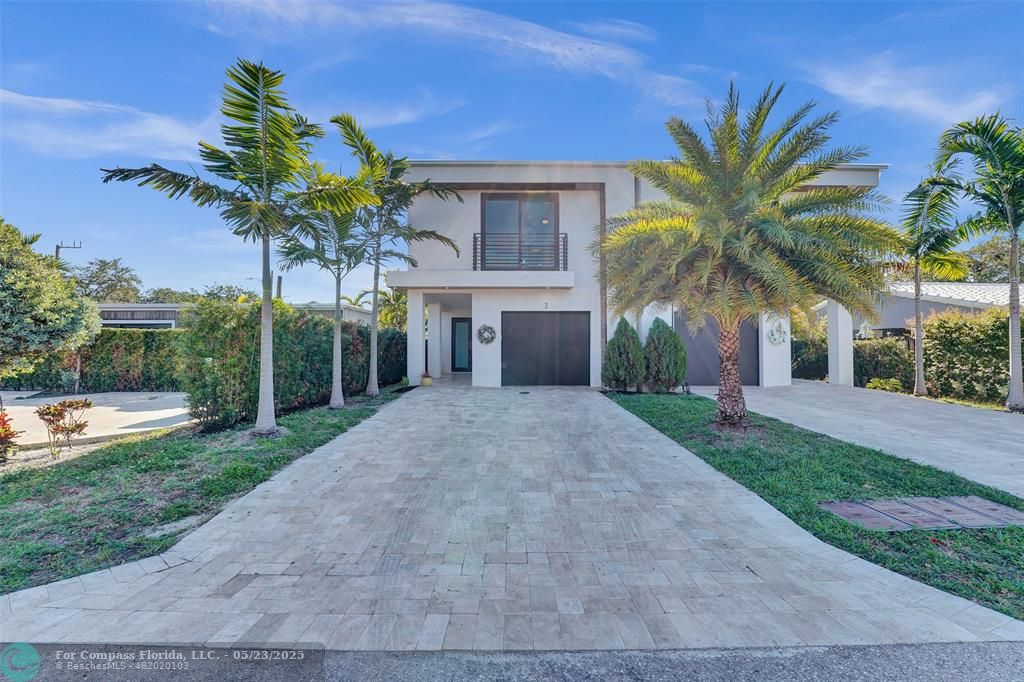 1238 Northeast 17th Avenue, Unit 2 Fort Lauderdale, FL 33304 - Photo 1 of 40 a palm tree sitting in front of a house with a yard