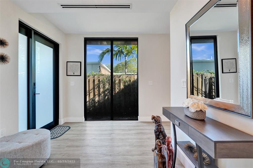 1238 Northeast 17th Avenue, Unit 2 Fort Lauderdale, FL 33304 - Photo 13 of 40 a view of a livingroom with furniture and front door