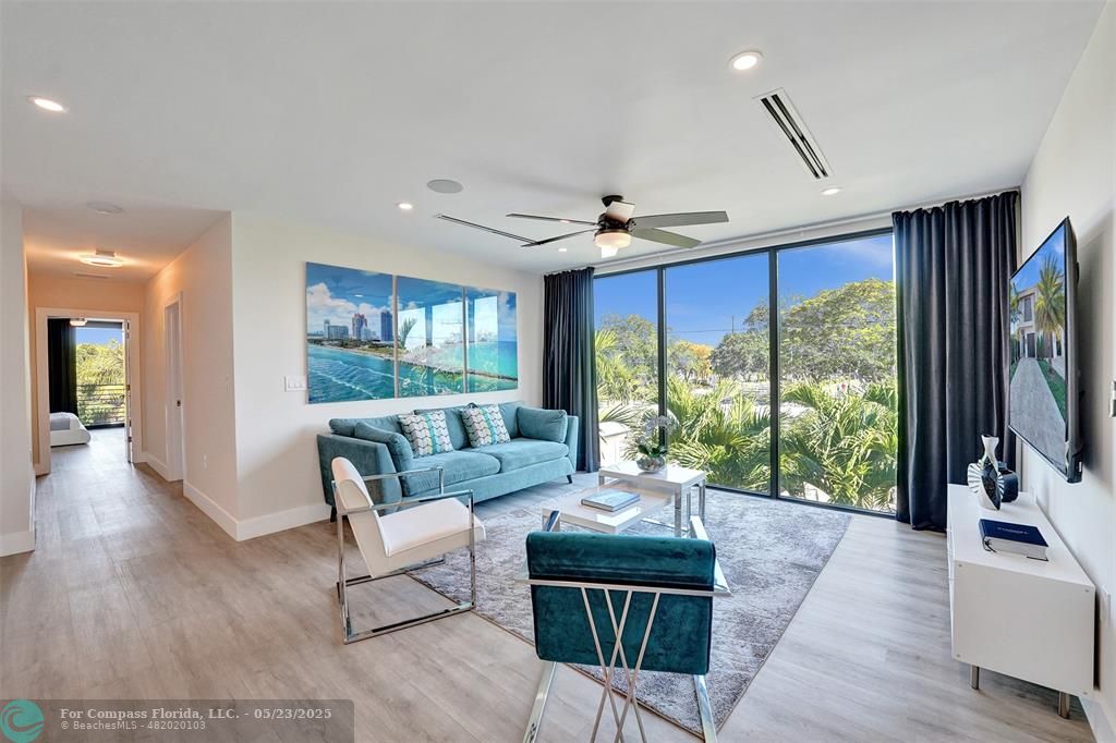 1238 Northeast 17th Avenue, Unit 2 Fort Lauderdale, FL 33304 - Photo 16 of 40 a living room with furniture large window and wooden floor