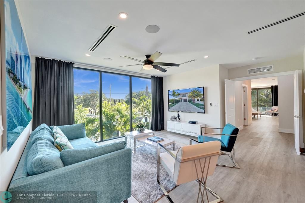 1238 Northeast 17th Avenue, Unit 2 Fort Lauderdale, FL 33304 - Photo 17 of 40 a living room with furniture and a large window