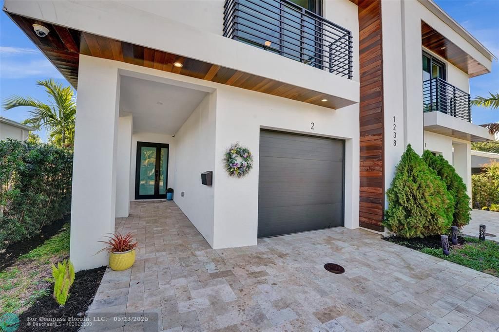 1238 Northeast 17th Avenue, Unit 2 Fort Lauderdale, FL 33304 - Photo 2 of 40 a view of a back yard of the building
