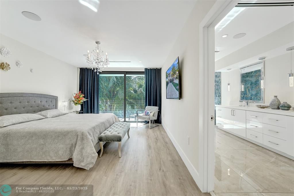 1238 Northeast 17th Avenue, Unit 2 Fort Lauderdale, FL 33304 - Photo 21 of 40 a spacious bedroom with a bed and glass walk in closet
