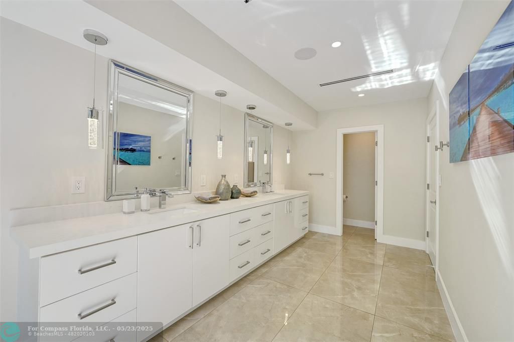 1238 Northeast 17th Avenue, Unit 2 Fort Lauderdale, FL 33304 - Photo 25 of 40 a spacious bathroom with a double vanity sink mirror and shower