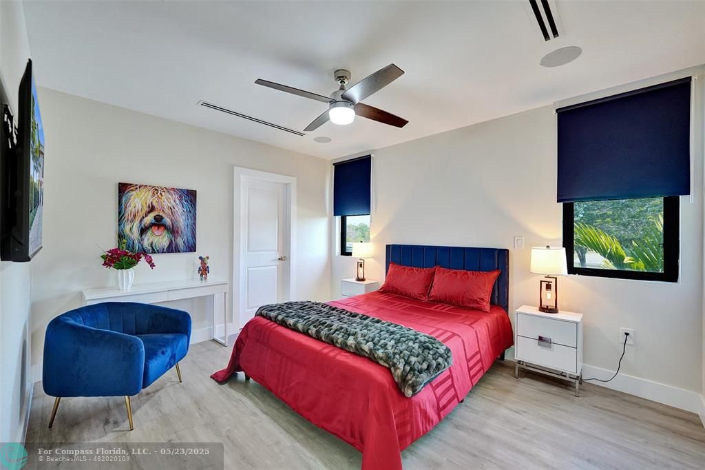 1238 Northeast 17th Avenue, Unit 2 Fort Lauderdale, FL 33304 - Photo 29 of 40 a bedroom with a bed a couch and a painting on the wall