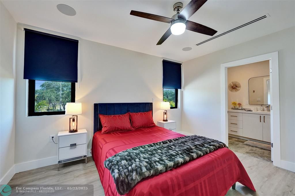 1238 Northeast 17th Avenue, Unit 2 Fort Lauderdale, FL 33304 - Photo 30 of 40 a bedroom with a large bed and a chandelier