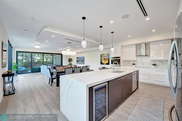 a large kitchen with kitchen island a island a sink a stove and a large window