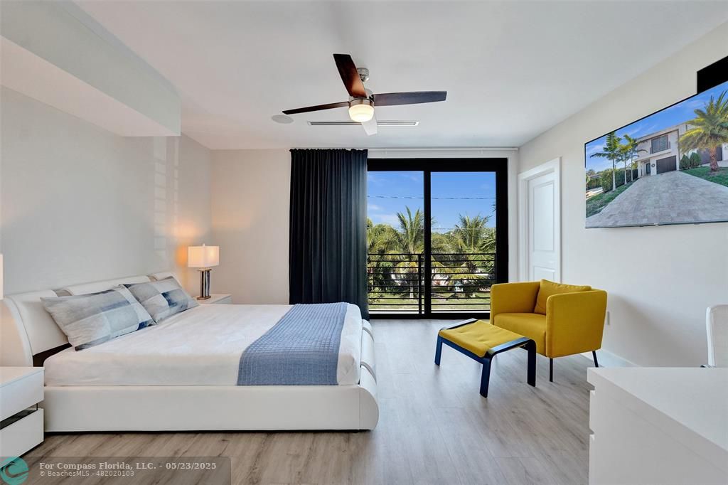 1238 Northeast 17th Avenue, Unit 2 Fort Lauderdale, FL 33304 - Photo 32 of 40 a bedroom with a bed and a chair