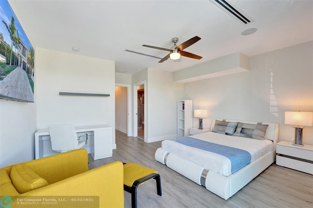 1238 Northeast 17th Avenue, Unit 2 Fort Lauderdale, FL 33304 - Photo 33 of 40 a bedroom with a bed a couch and a lamp on a dresser