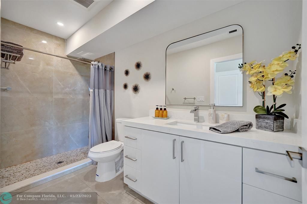 1238 Northeast 17th Avenue, Unit 2 Fort Lauderdale, FL 33304 - Photo 35 of 40 a bathroom with a sink toilet and shower