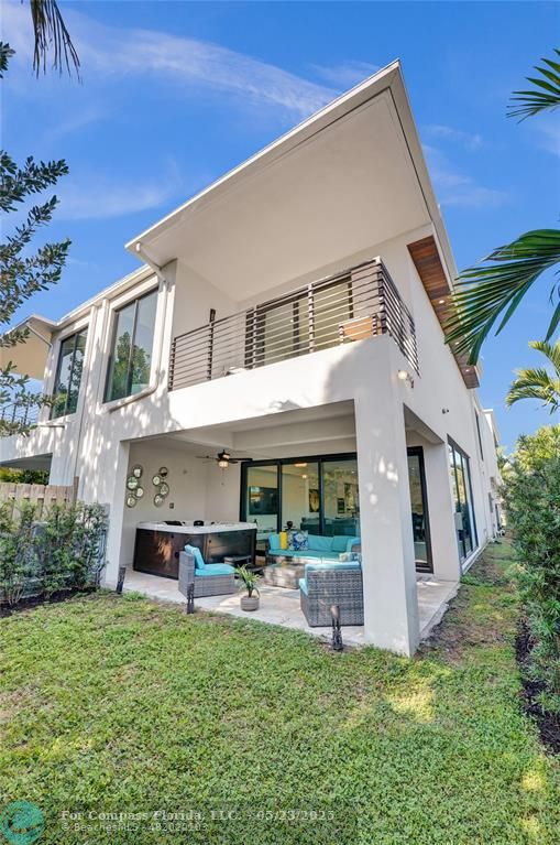 1238 Northeast 17th Avenue, Unit 2 Fort Lauderdale, FL 33304 - Photo 39 of 40 a backyard of a house with table and chairs