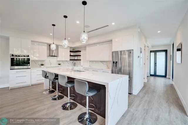 a large kitchen with a table and chairs