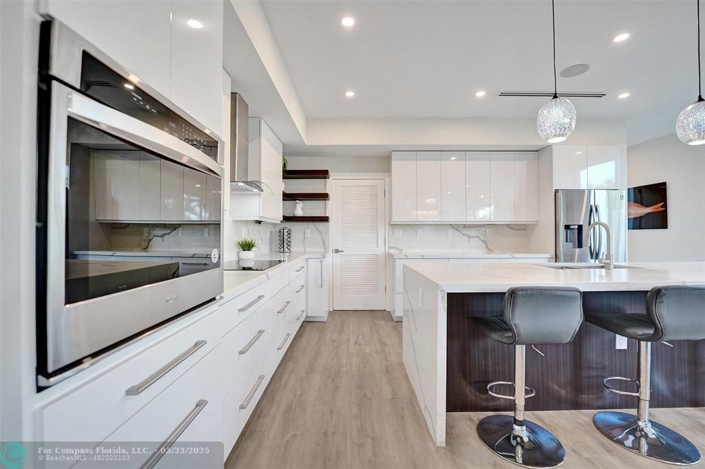 1238 Northeast 17th Avenue, Unit 2 Fort Lauderdale, FL 33304 - Photo 6 of 40 a large kitchen with a counter space a sink appliances and cabinets